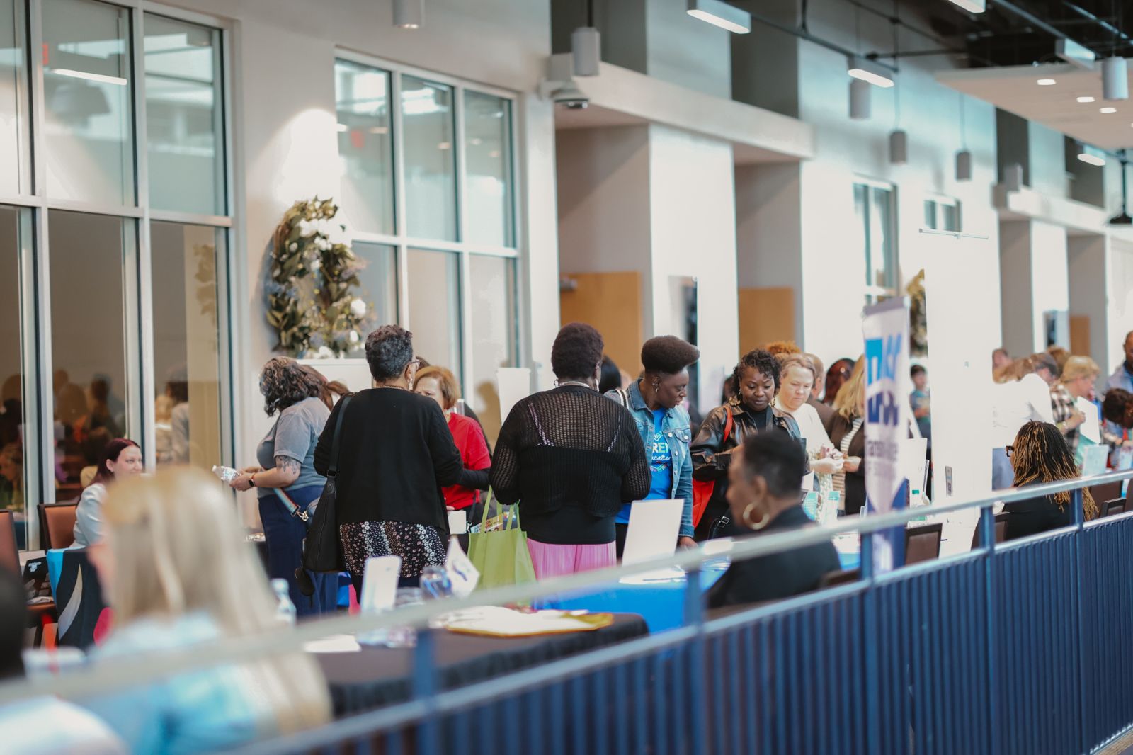 Image of people walking in an open hallway.