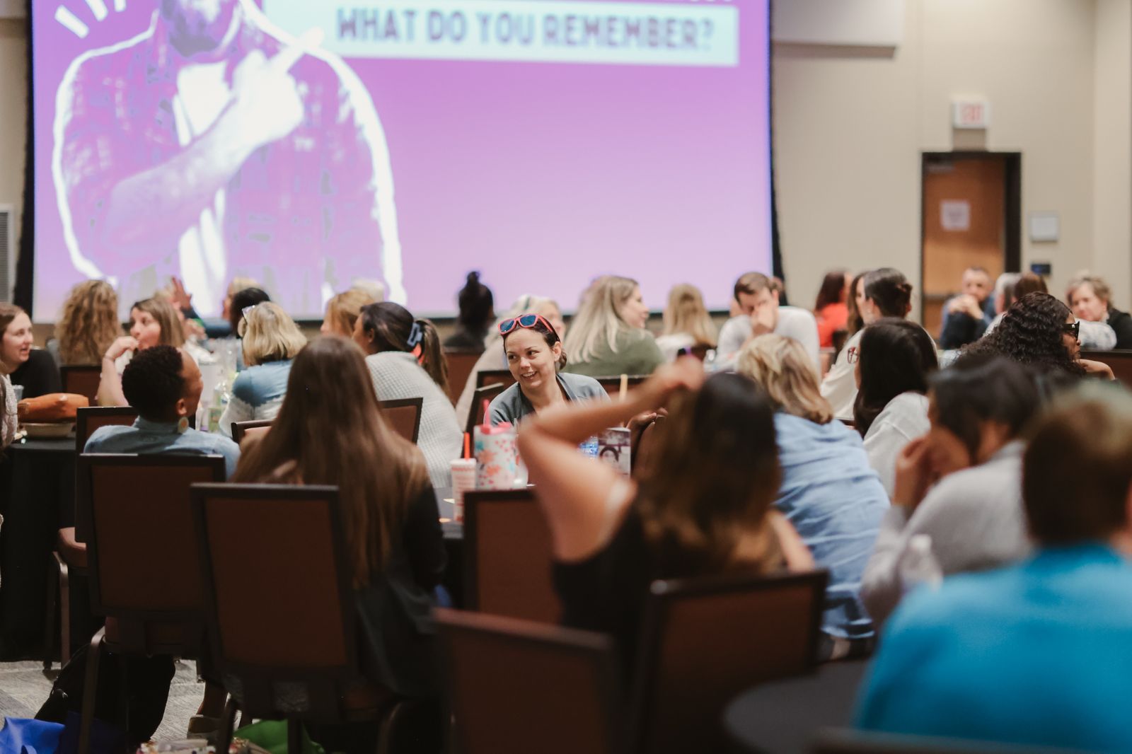 Image of people in a large conference room.