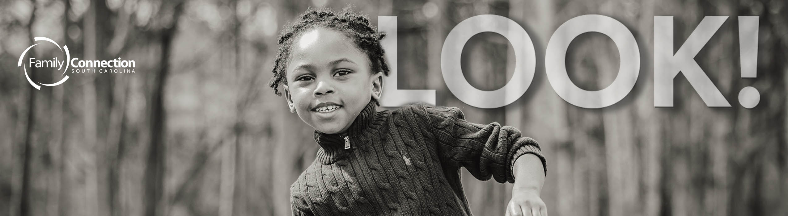Loo Banner. Child smiling with a forest behind her.